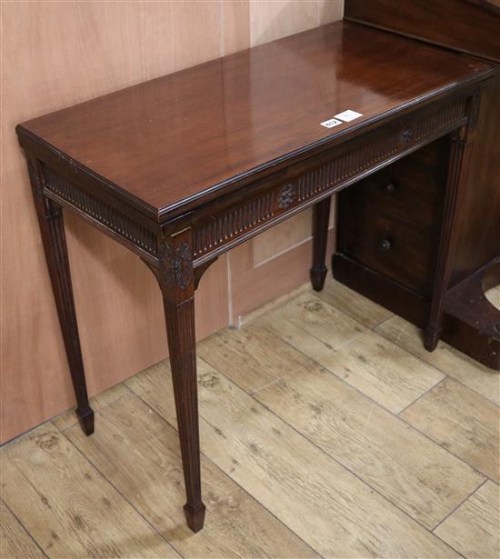 An Edwardian mahogany card table